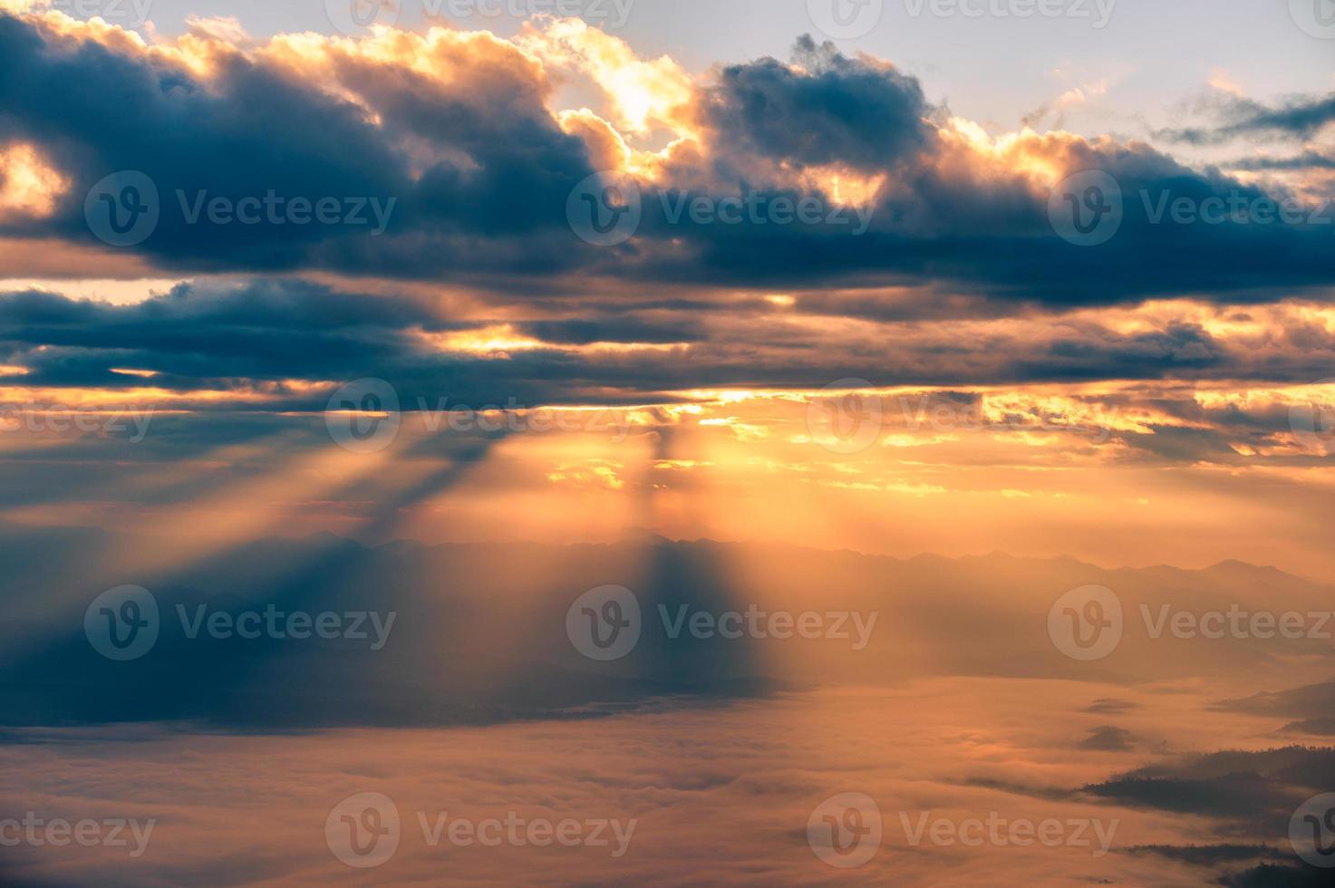 Golden shining sky over mountain and foggy in the morning at national park photo