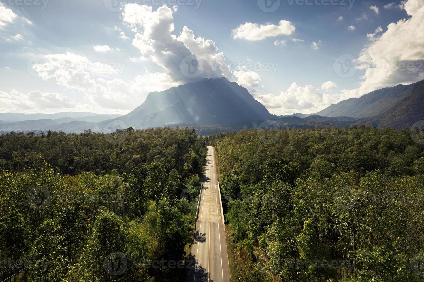 Aerial view of Doi Luang Chiang Dao mountain with straight road among the forest on bright day photo