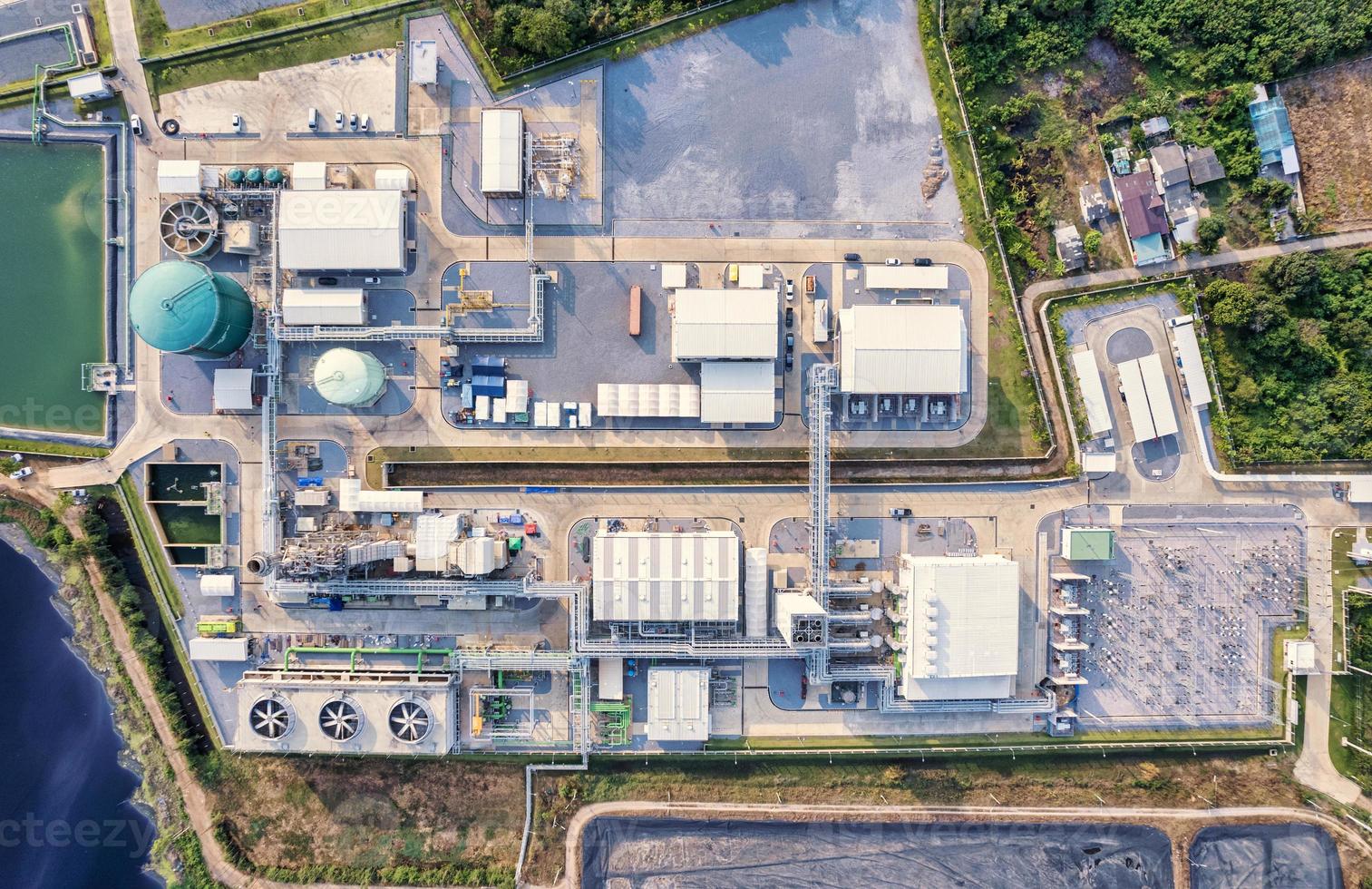 Electrical substation power plant, high voltage electricity with pipeline and tank warehouse in power generation plant photo