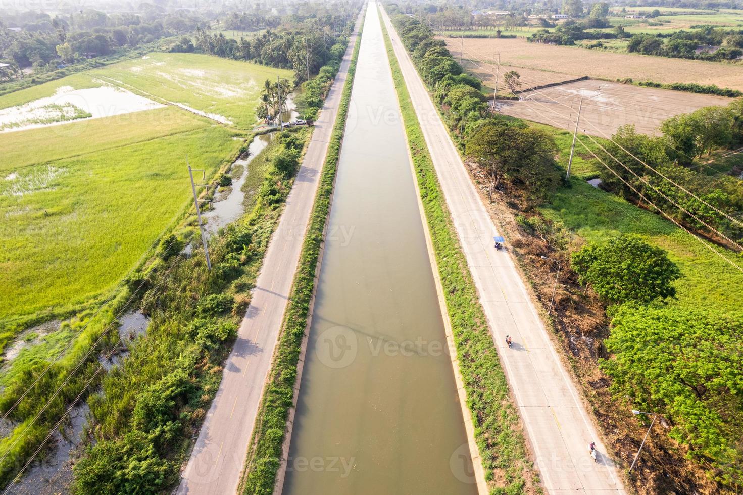 Aerial view of straight irrigation canal system management among the rice field and agronomic in countryside photo