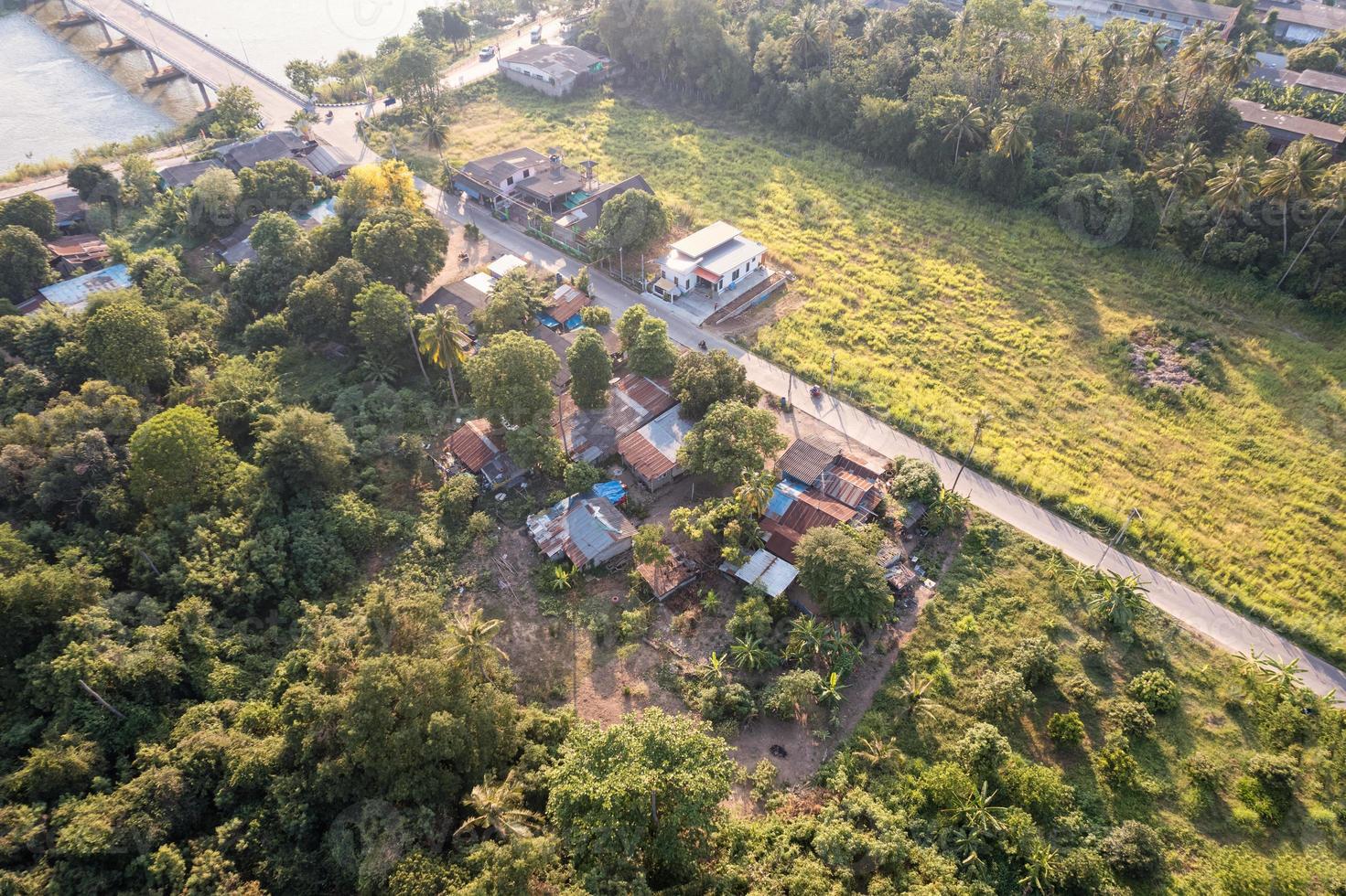 Aerial view of small town or local village among agricultural plantation in countryside photo
