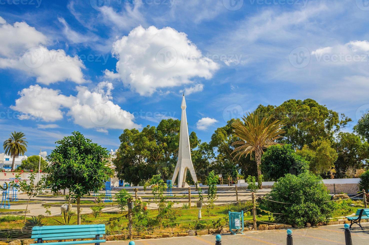 Monument with blue sky and trees near Medina in Hammamet Tunisia photo