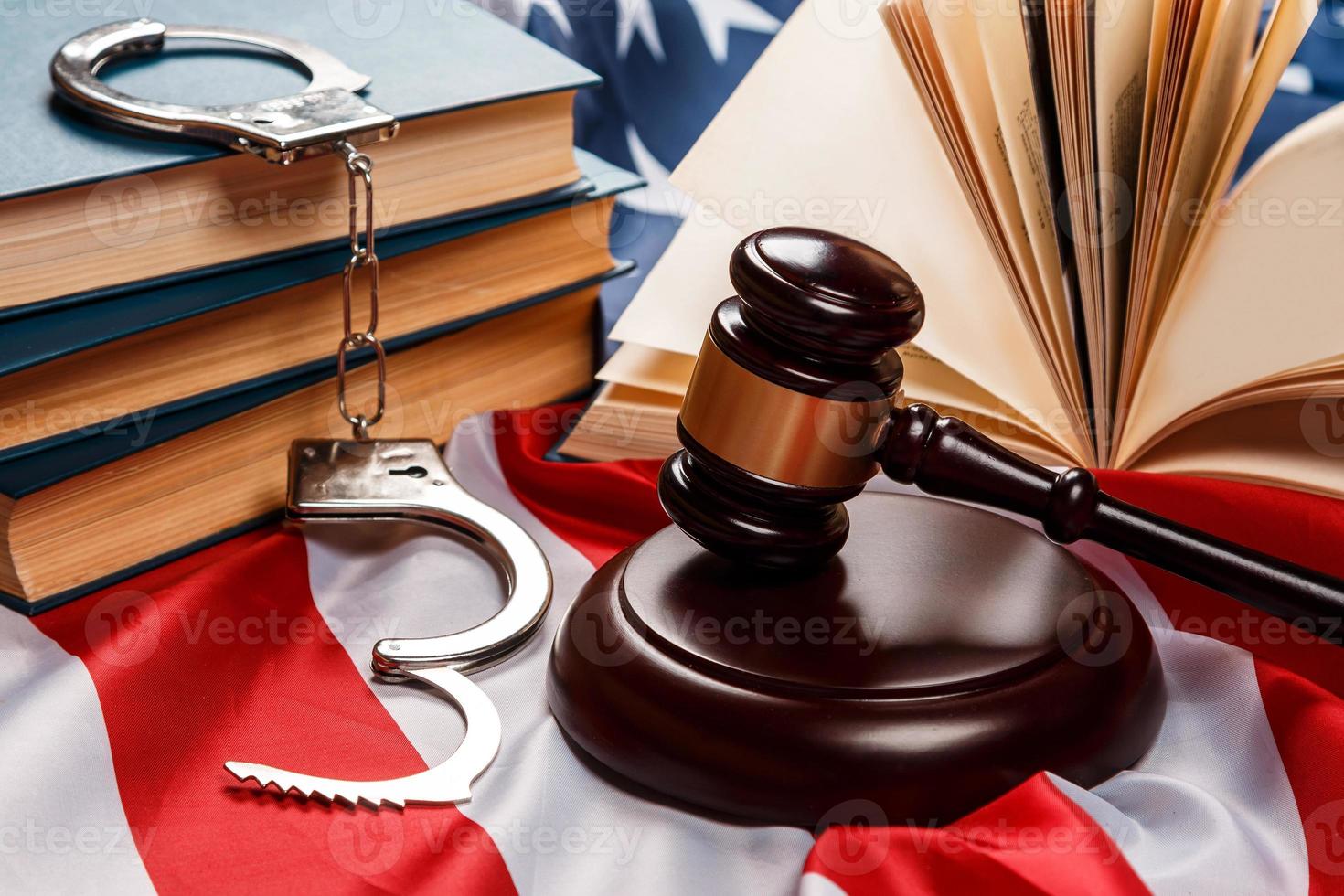 Gavel, books and handcuffs photo
