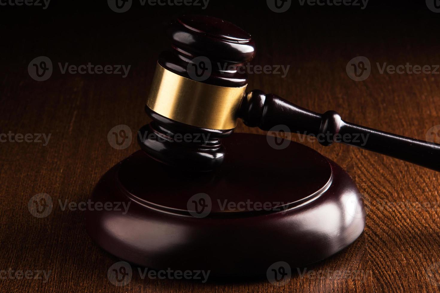 Judge hammer on wooden background photo