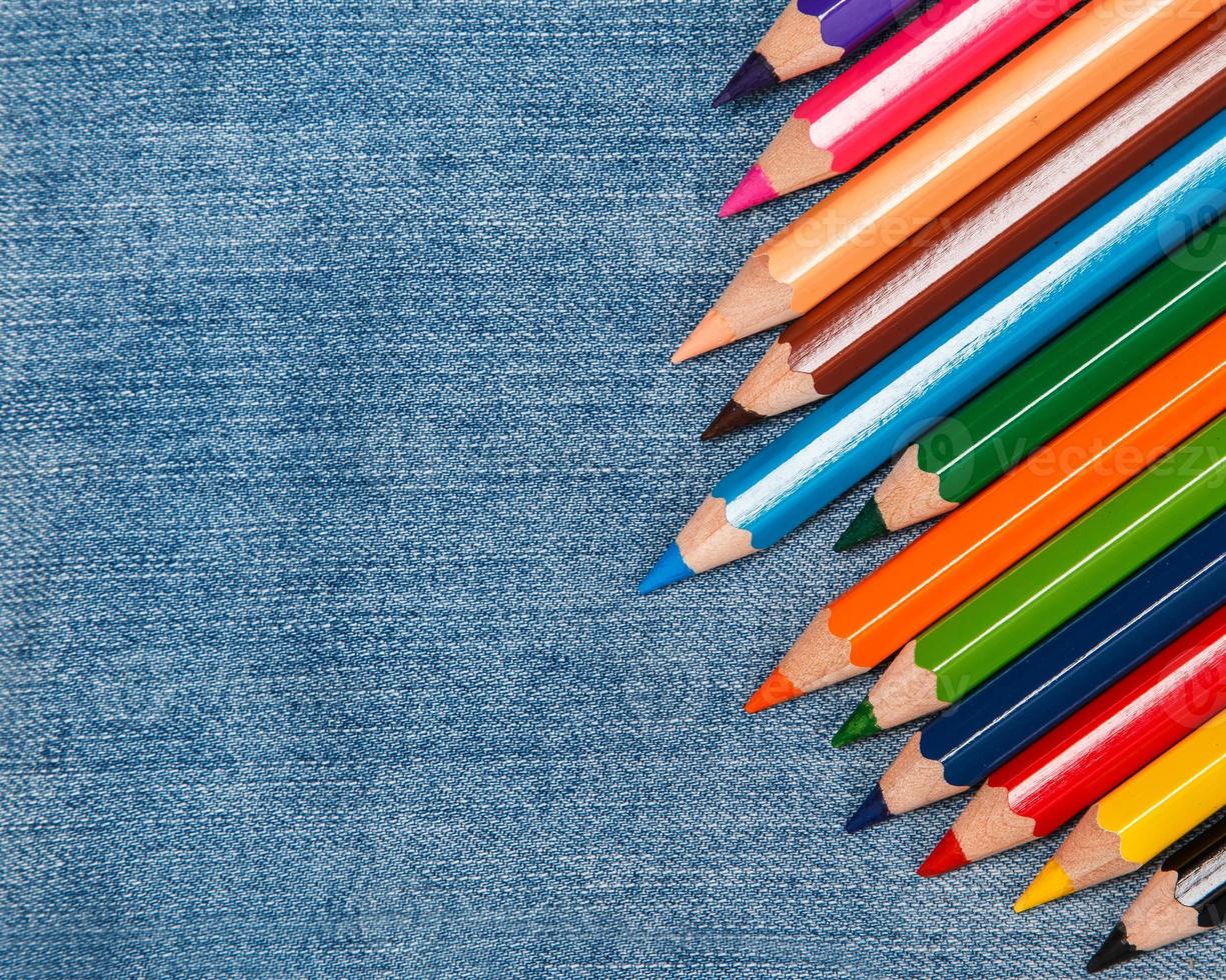 Pencils over jeans surface photo