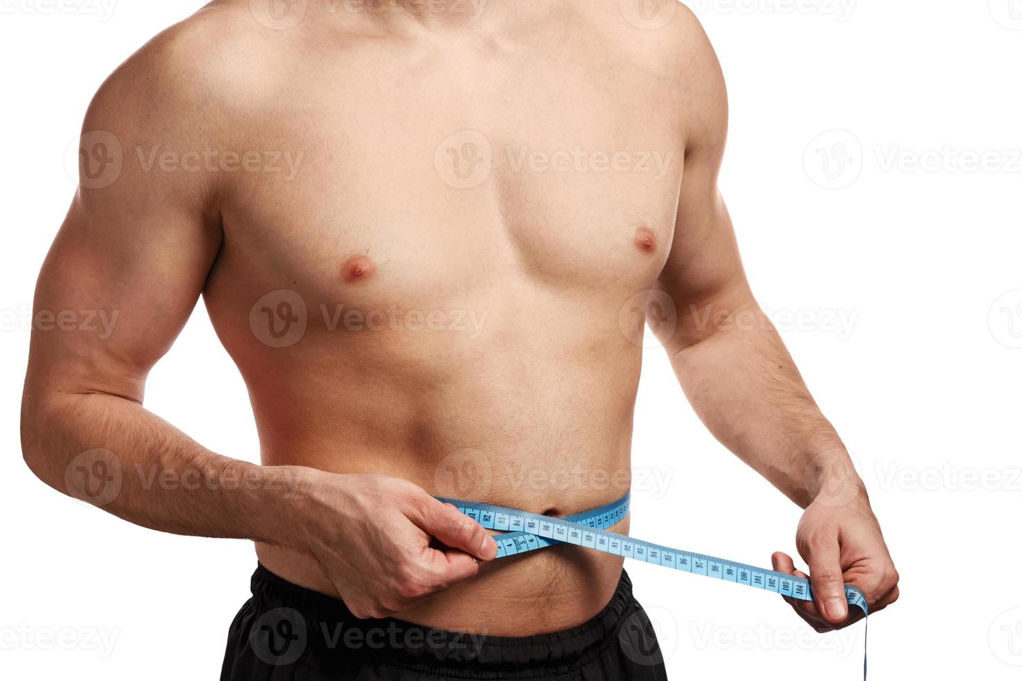 Male torso with measure tape on waistline photo