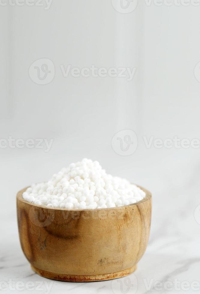 Selective Focus White Sago Pearl on Wooden Bowl photo
