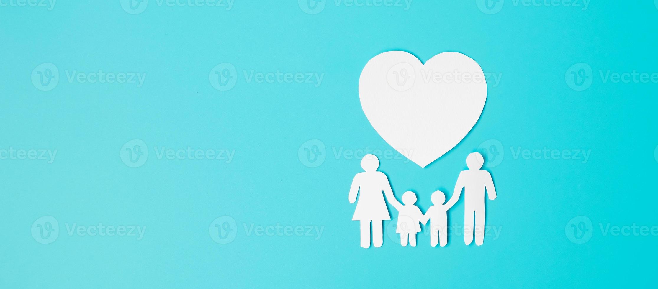 Happy Family day. paper shape cutout with Father, Mother, Children and heart. international day of families, Warm home, love, Foster, Insurance, Charity and Donation concepts. photo