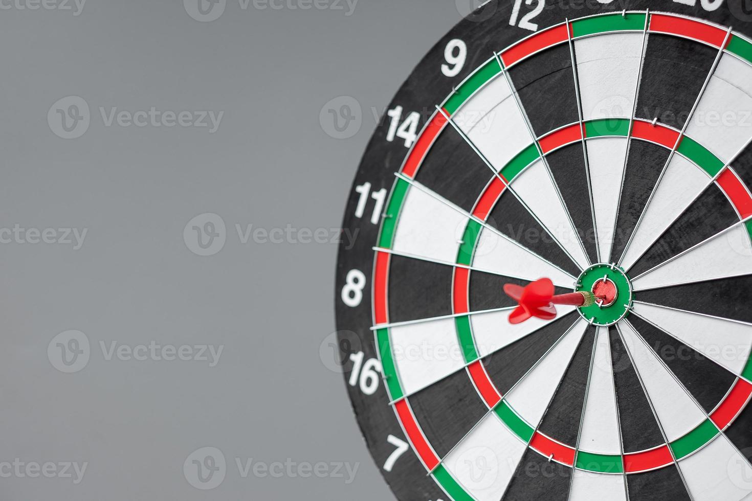 Red dart hitting a target on center of Bullseye or Dartboard. Business, competition, goal, success and marketing concept photo