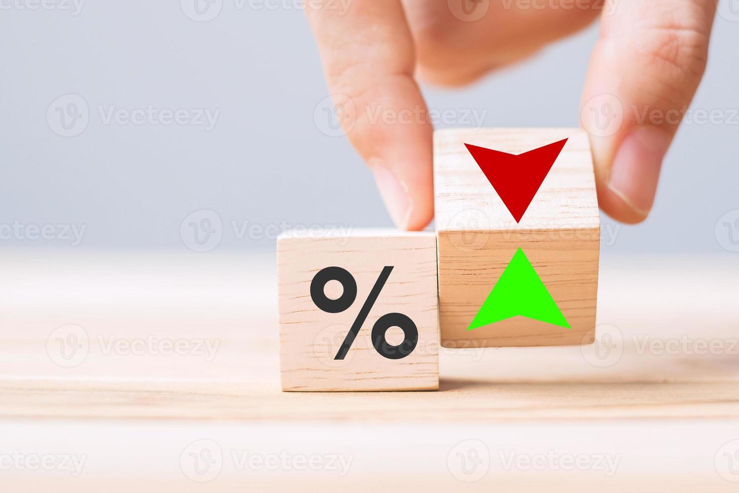 business man Hand change wood cube block with percentage to UP and Down arrow symbol icon. Interest rate, stocks, financial, ranking, mortgage rates and Cut loss concept photo