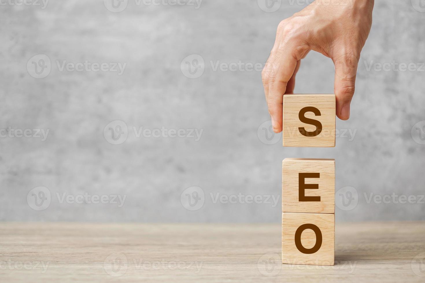 SEO Search Engine Optimization text wooden cube blocks on table background. Idea, Strategy, advertising, marketing, Keyword and Content concept photo