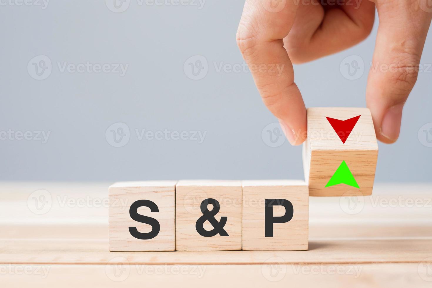 business man Hand change wood cube block with SP text to UP and Down arrow symbol icon. Interest rate, stocks, financial, ranking, mortgage rates and Cut loss concept photo