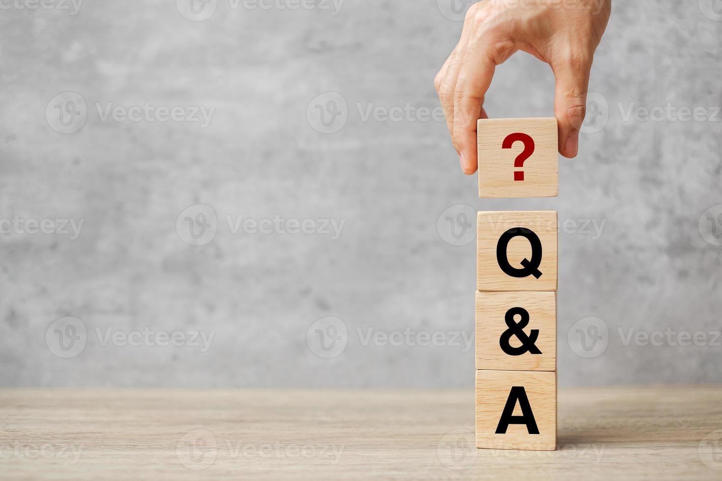 Hand holding Q and A word with wooden block. FAQ  frequency asked questions, Answer, Question  Ask, Information, Communication and Brainstorming Concepts photo