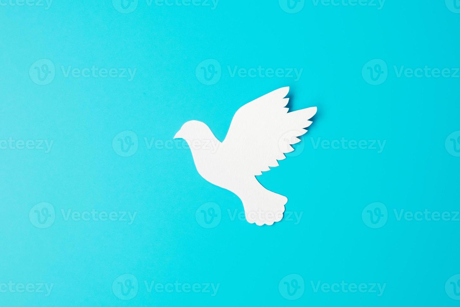 International Day of Peace. white paper Dove bird on blue background. Freedom, Hope and World Peace day 21 September concepts. photo