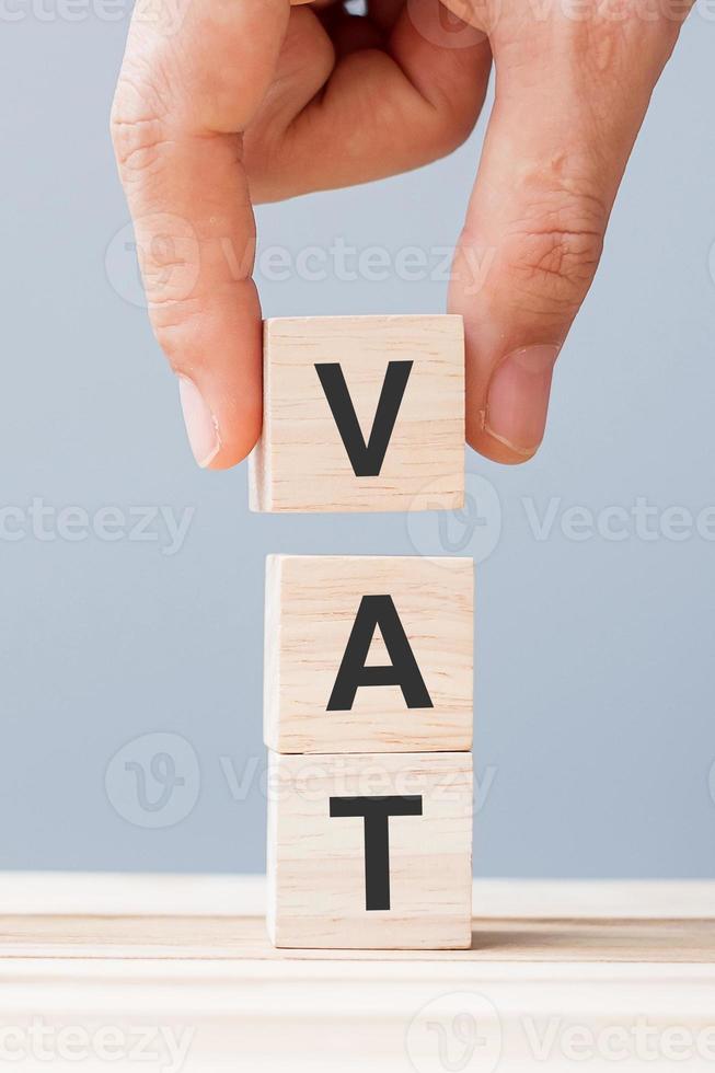 hand holding wood cube block with VAT text . Financial, Management, Economic, business concept photo