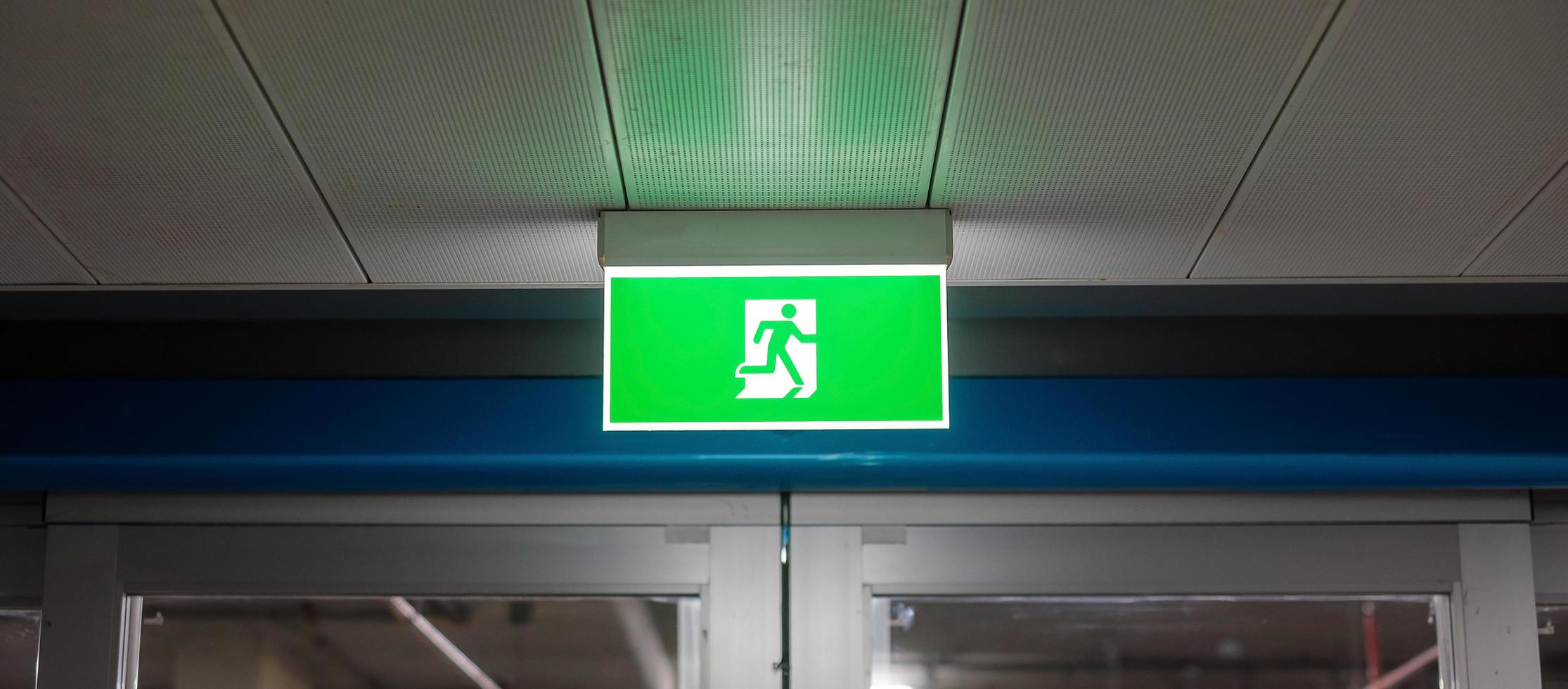 Fire Emergency exit sign on the wall inside building at subway train station. Safety concept photo