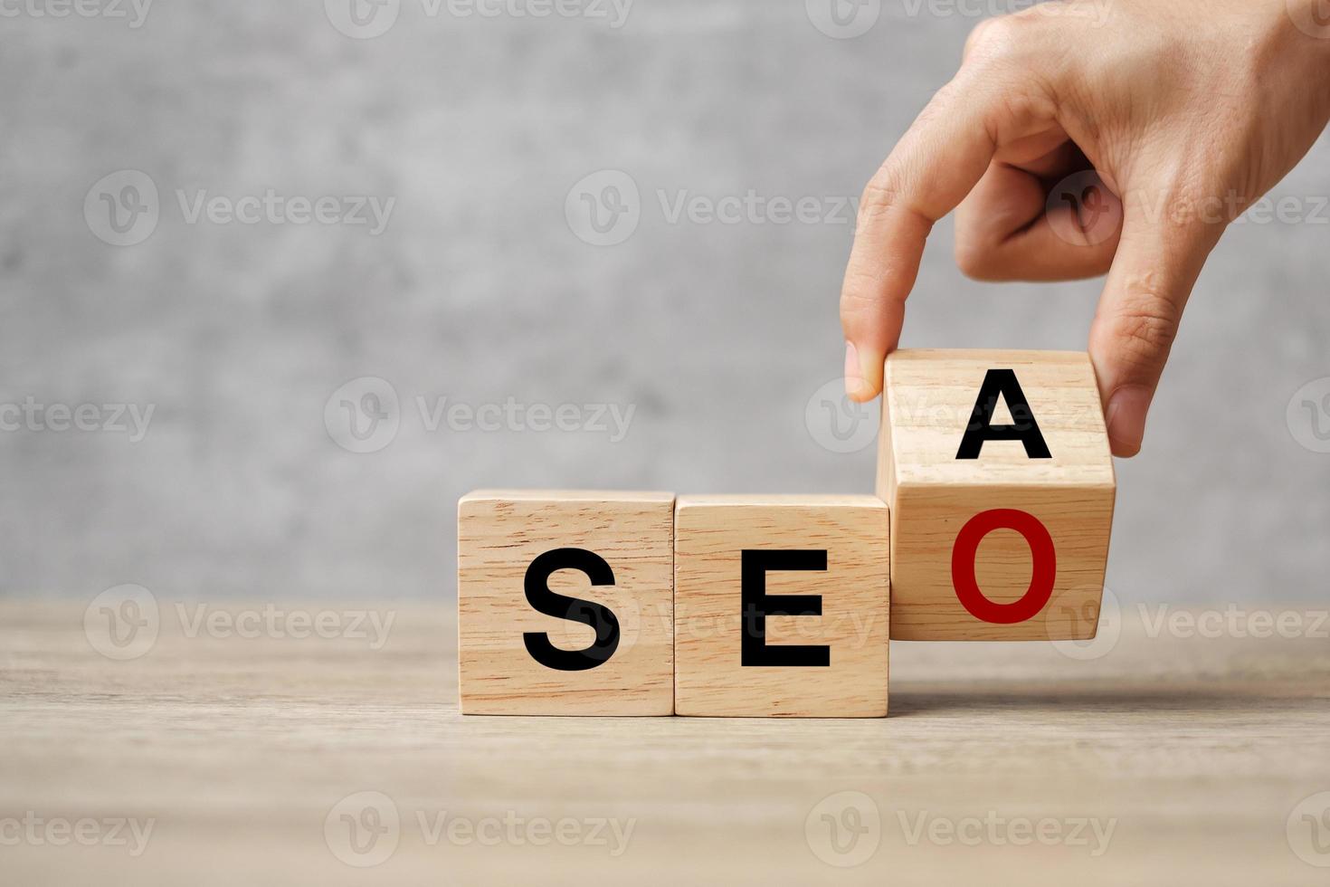 Hand flip SEA to SEO text wooden cube blocks on table background. Search Engine Optimization, Advertising, Idea, Strategy, marketing, Keyword and Content concept photo