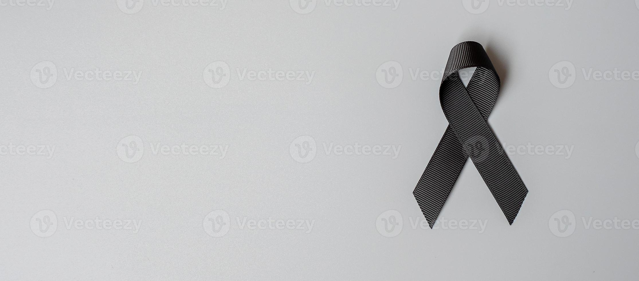 Melanoma and skin cancer, Vaccine injury awareness month and rest in peace concepts. black Ribbon on grey background photo