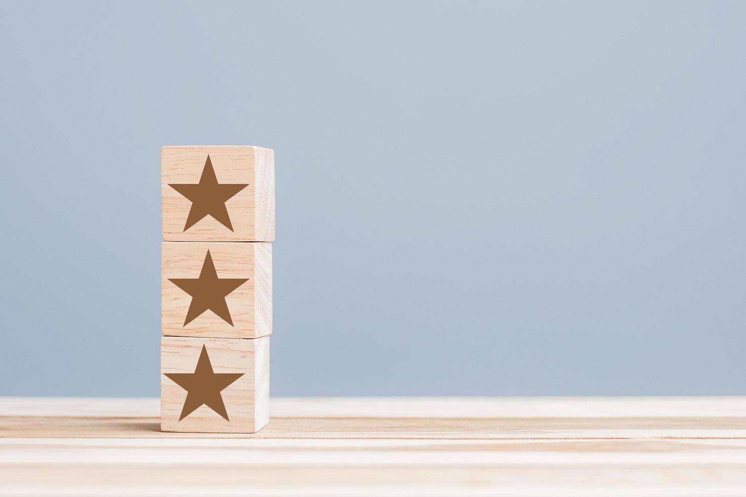 wooden blocks with the star symbol. Customer reviews, feedback, rating, ranking and service concept. photo