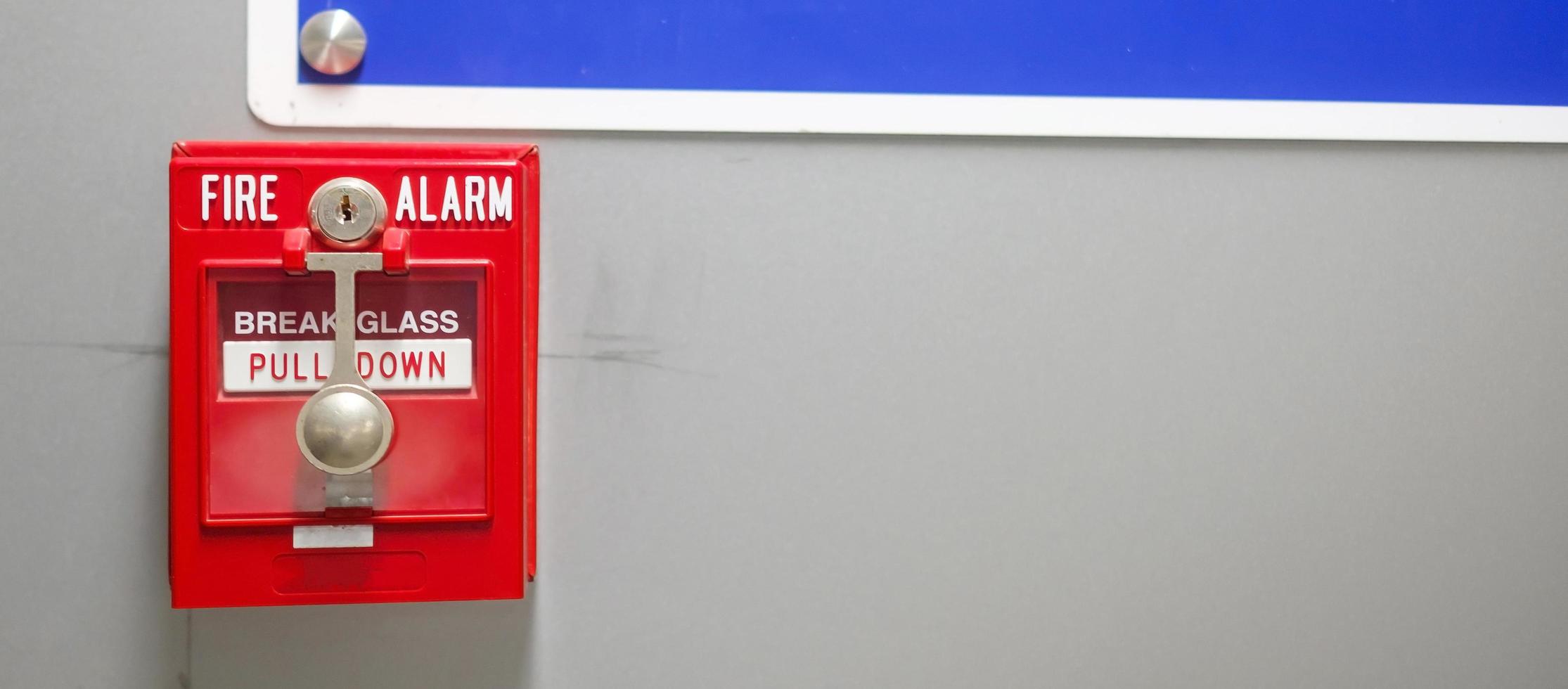 Fire alarm switch on the wall, powerful emergency equipment for industrial and residential photo