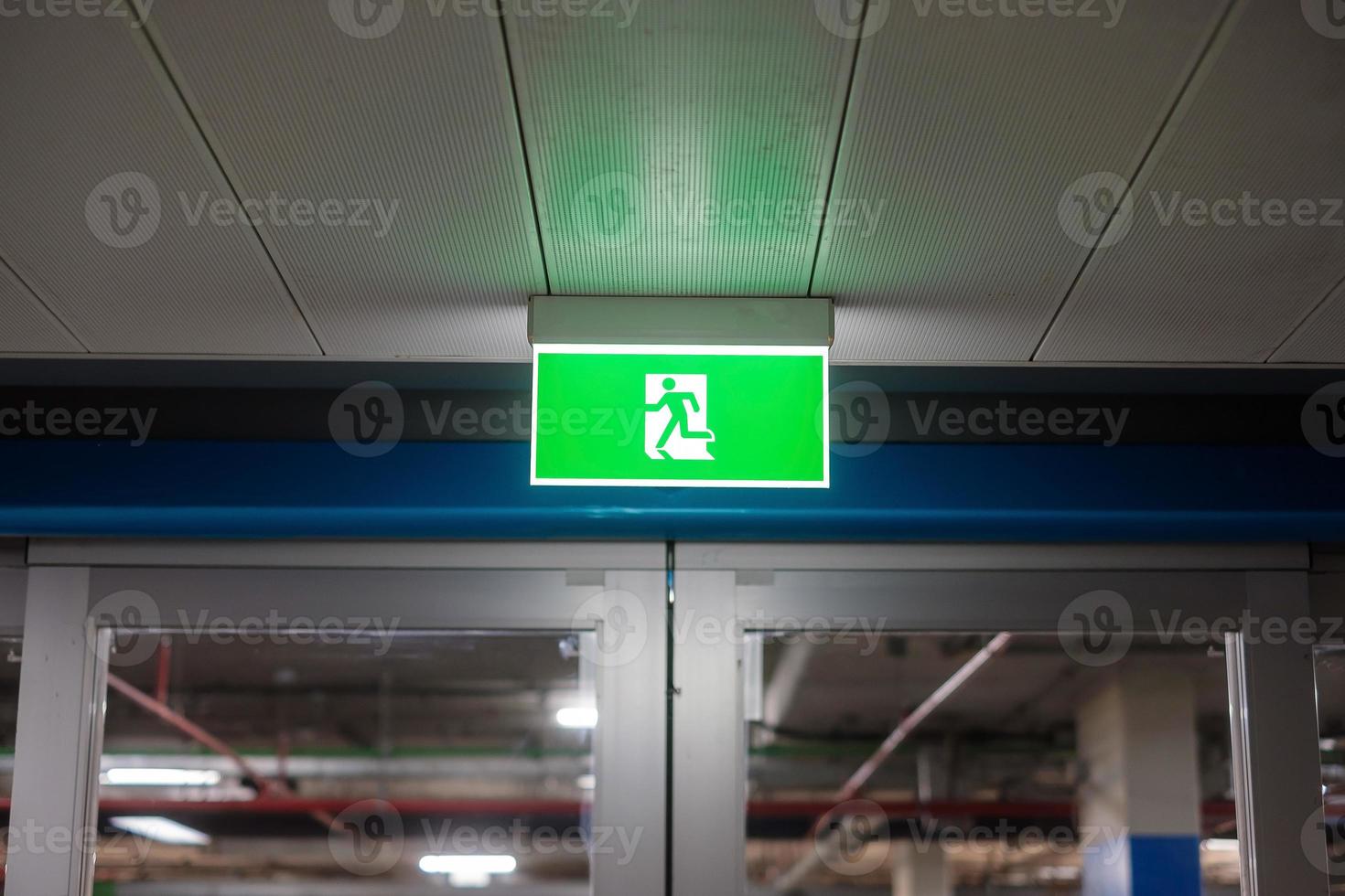 Fire Emergency exit sign on the wall inside building at subway train station. Safety concept photo