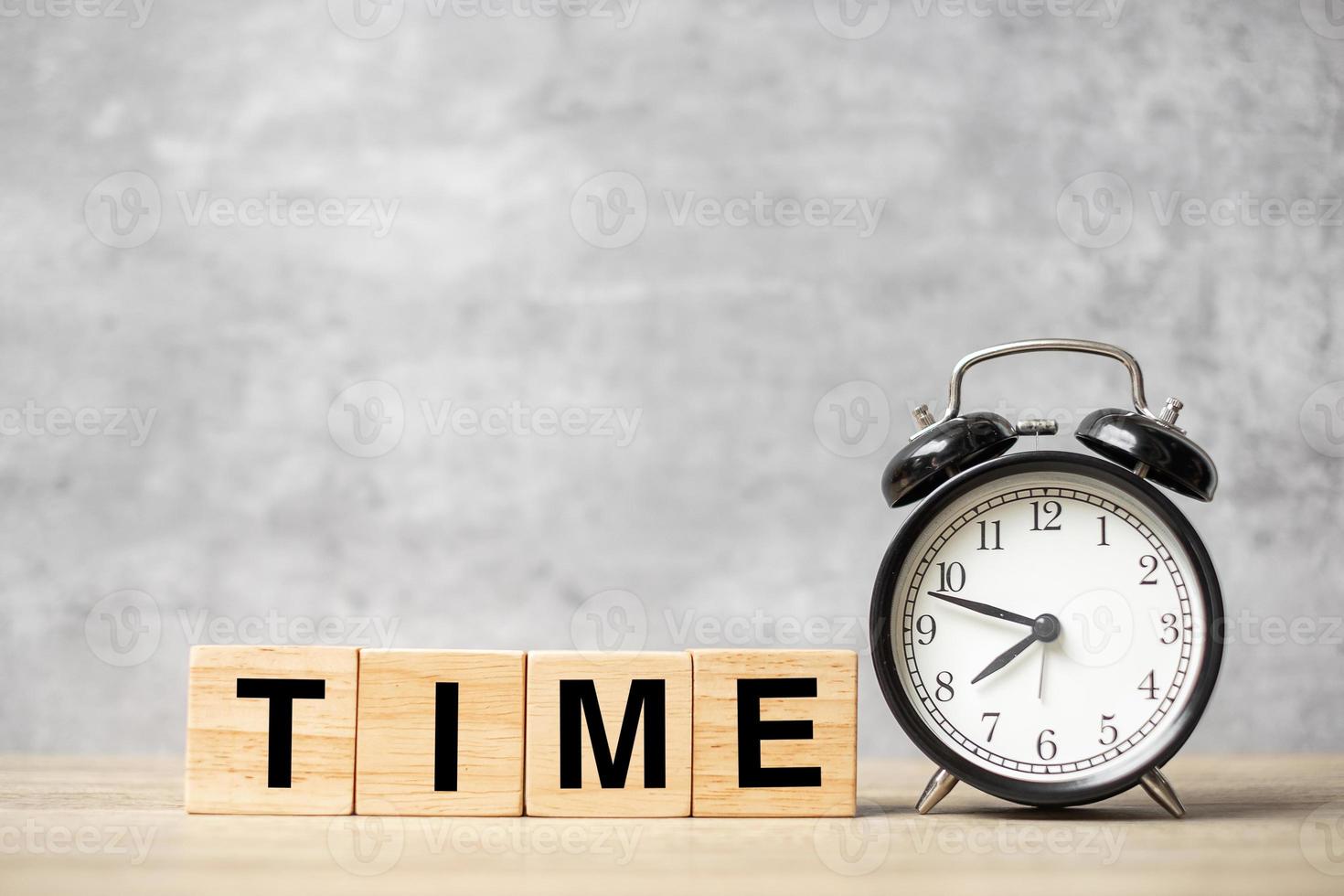 Vintage alarm clock with TIME block on table. Activity, daily routine, morning, workout and Work life balance concept photo