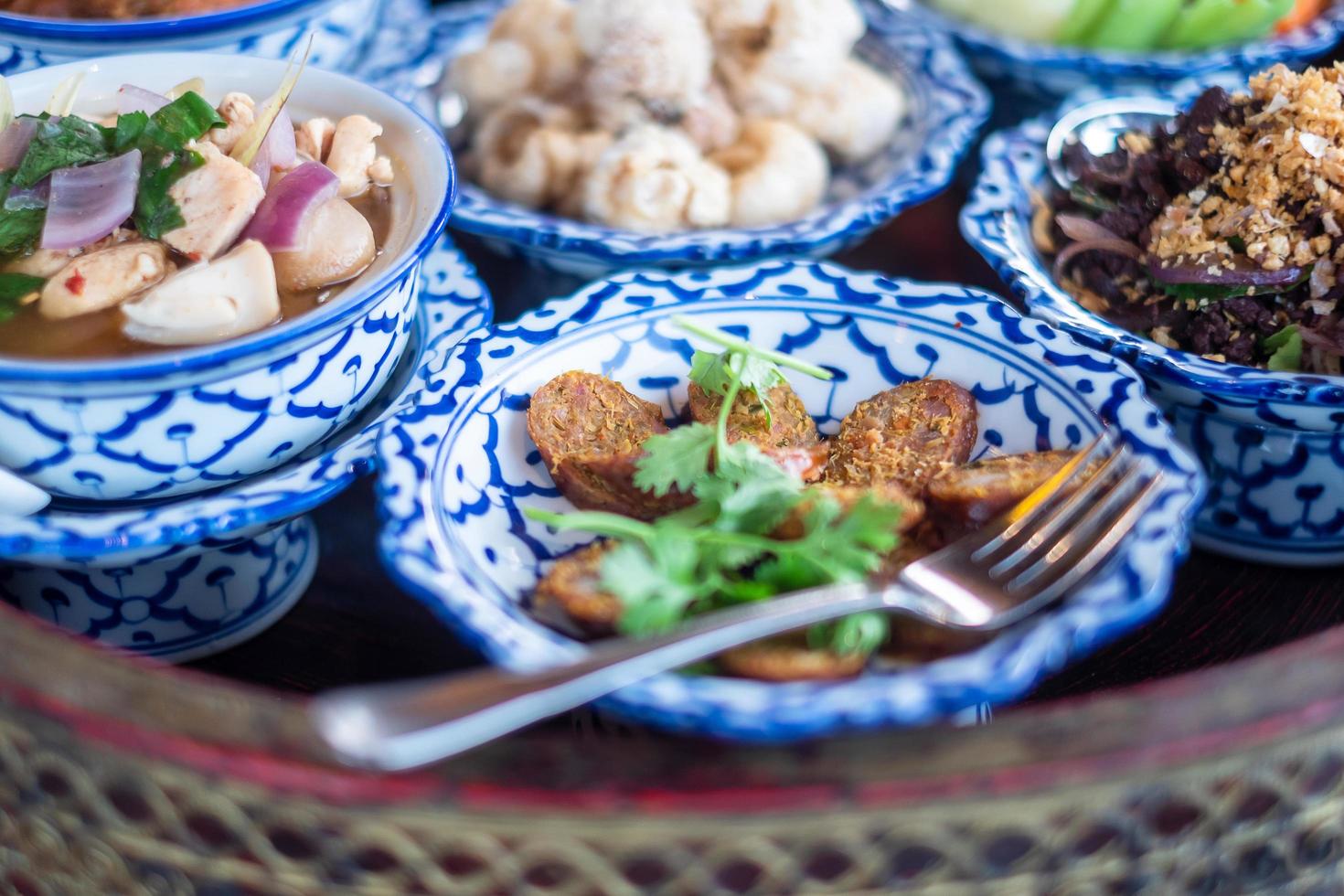 traditional Thai food on bamboo tray or Khan Toke, local food in Northern of Thailand photo