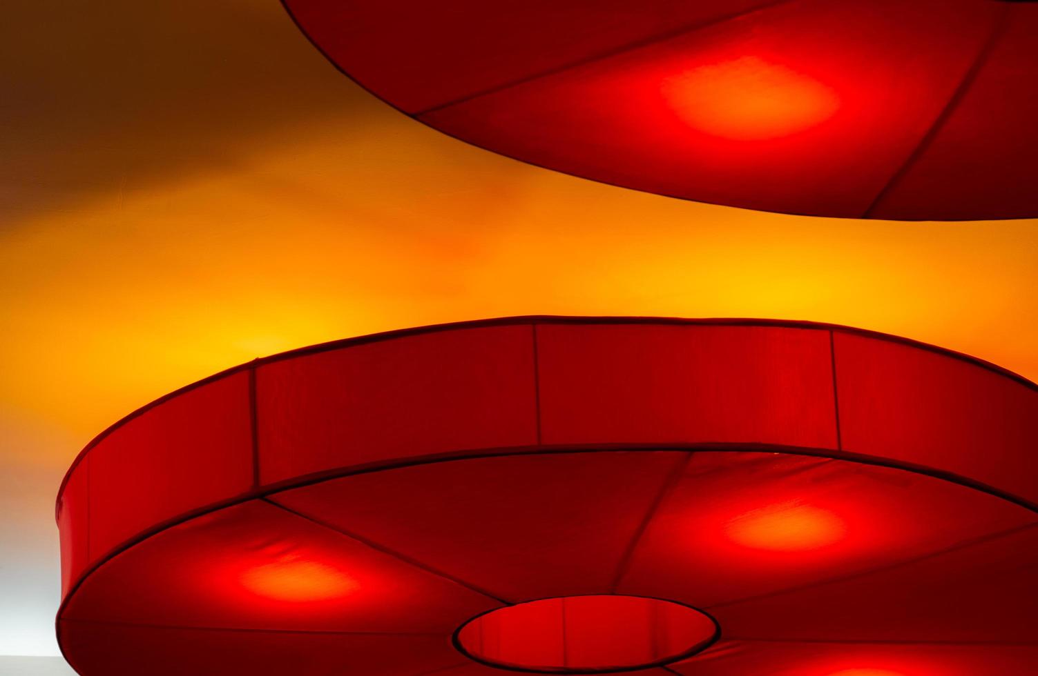 Interior ceiling red lights on dark background at night. Interior lighting concept. Red lights on ceiling wall. Interior architecture. photo