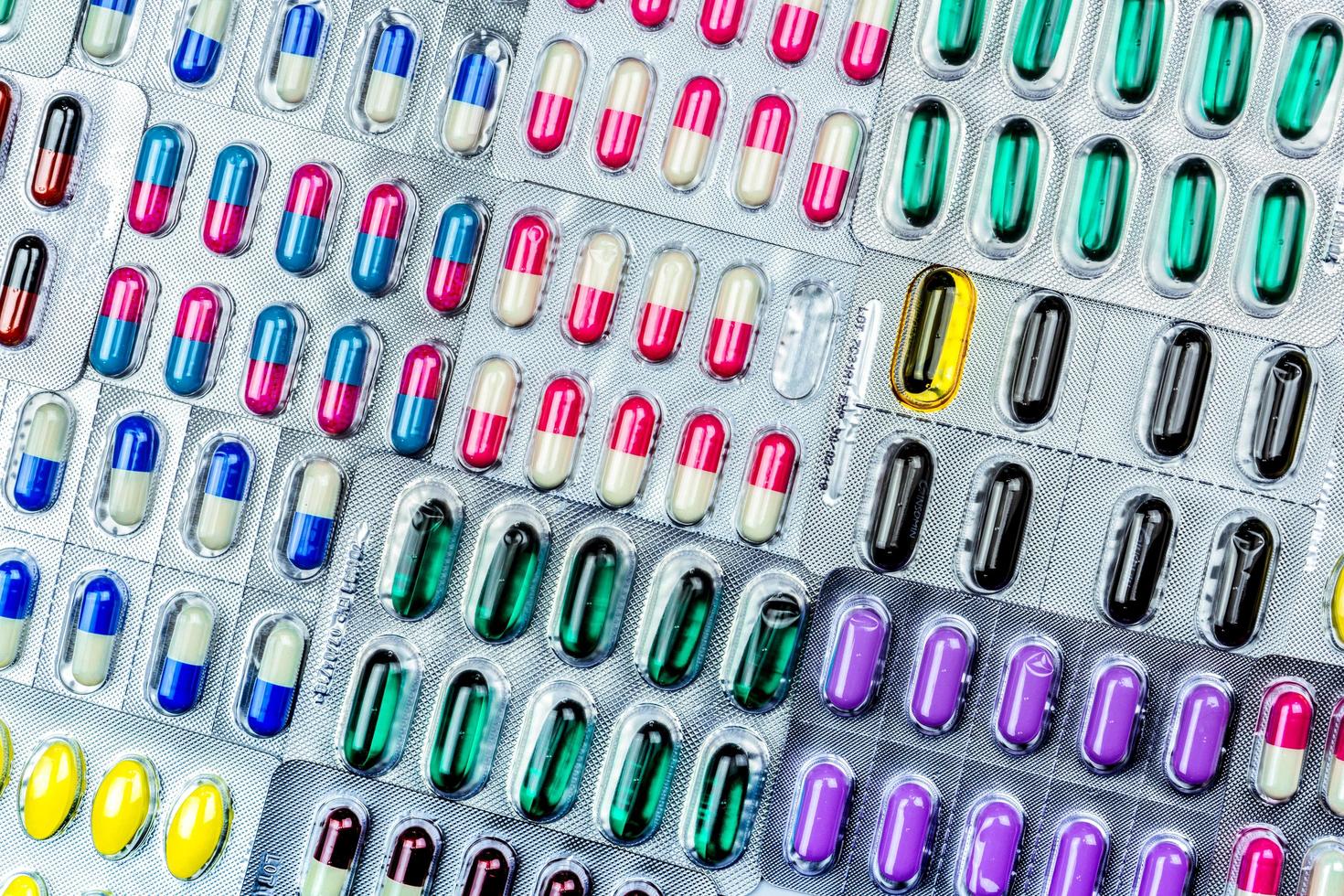 Colorful of tablets and capsules pill in blister packaging arranged with beautiful pattern with flare light. Pharmaceutical industry concept. Pharmacy drugstore. Antibiotic drug resistance. Defective. photo