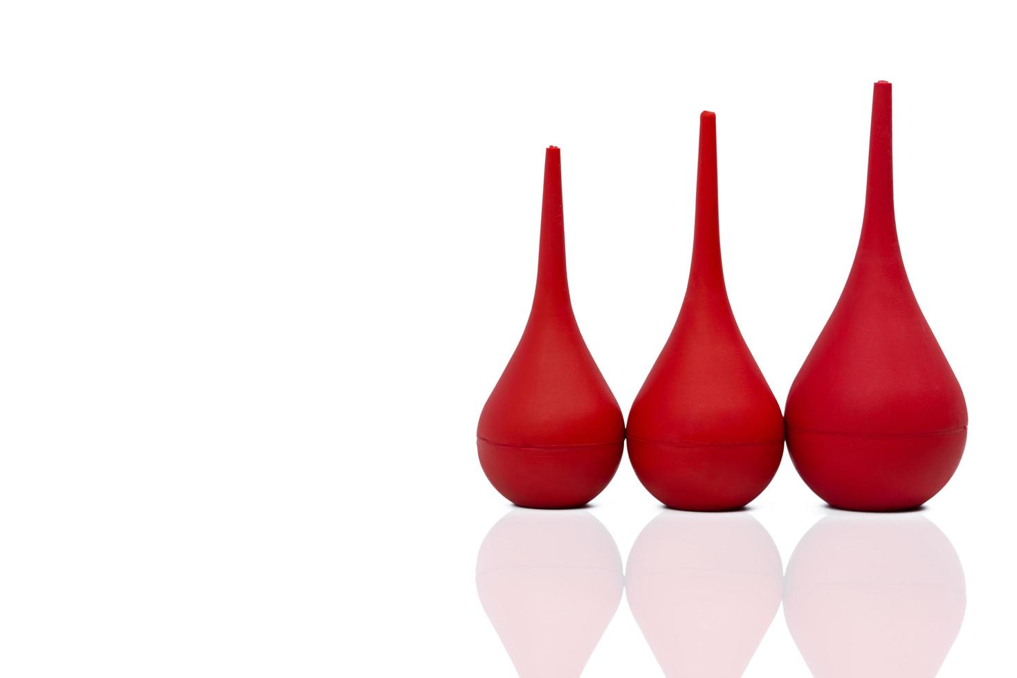 Red rubber syringe ball isolated on white background. Nasal aspirator. Baby ear syringe ball. Snot sucker and mucus sucker. Laboratory tool. Rubber suction syringe bulb. Ear washing squeeze bulb. photo
