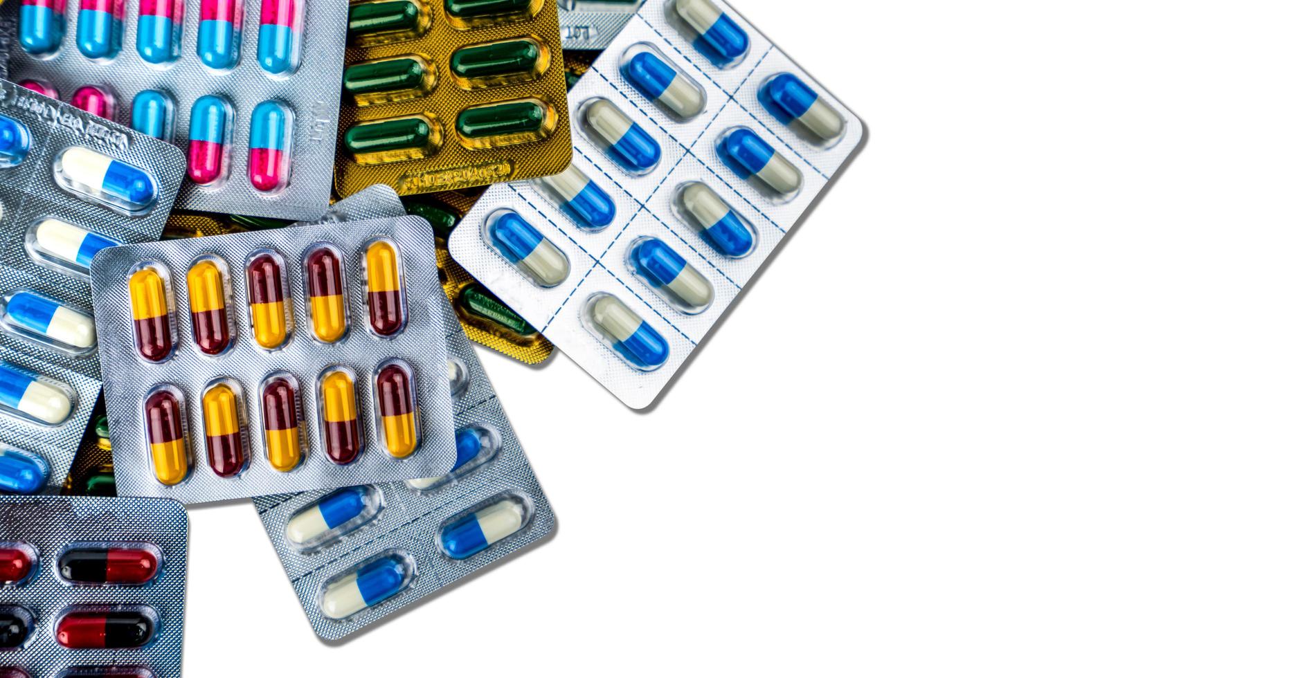 Top view of antibiotic capsule pills in blister pack isolated on white background. Pharmaceutical industry. Antibiotic drug resistance concept. Antimicrobial drugs. Colorful capsule pills. Healthcare. photo