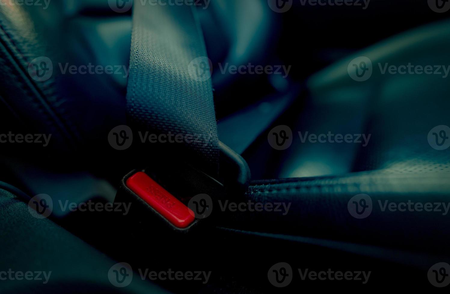 Car seat belt with red press button. Fasten seatbelt for safety and security and protect life from car accident. Buckle up black seat belt for safety. Buckle up seat belt it's the law. Safe road trip. photo
