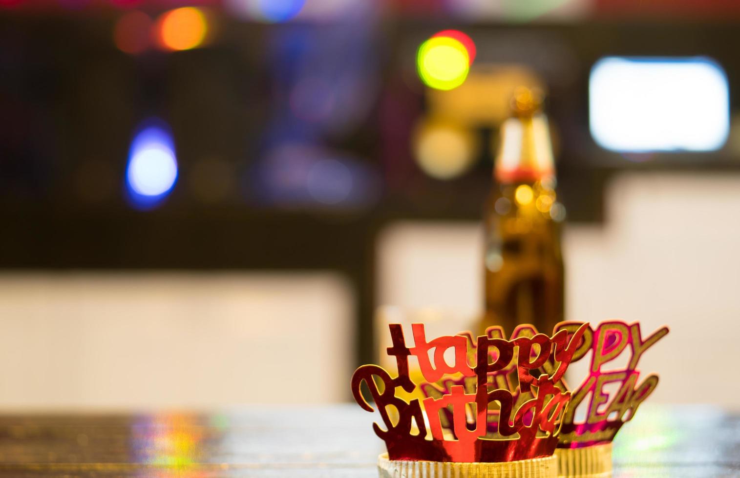 Red-golden Happy New Year headband on colorful bokeh background photo