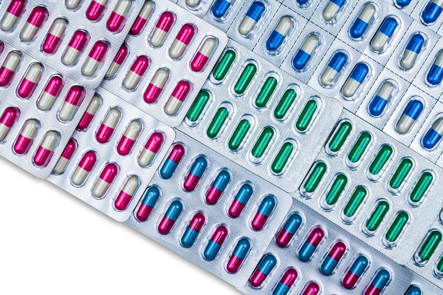 Top view of colorful capsule pills in blister pack arranged with beautiful pattern. Pharmaceutical packaging. Medicine for infections disease. Antibiotic drug use with reasonable. Drug resistance. photo