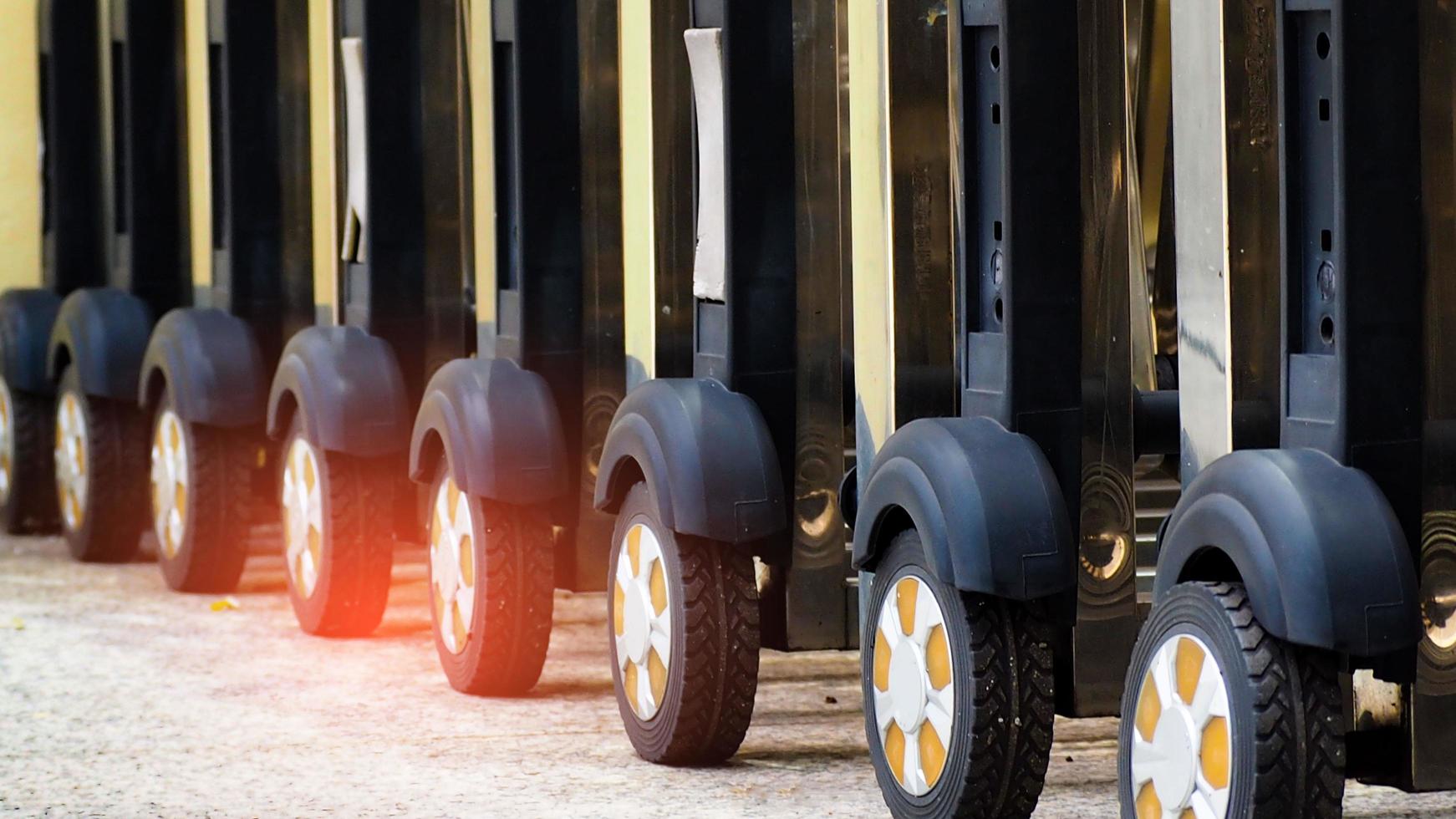 Selective focus on wheels of stainless steel movable fence. Foldable barrier fence use for security and safety at entrance of building or parking area. Shopping cart wheels. photo