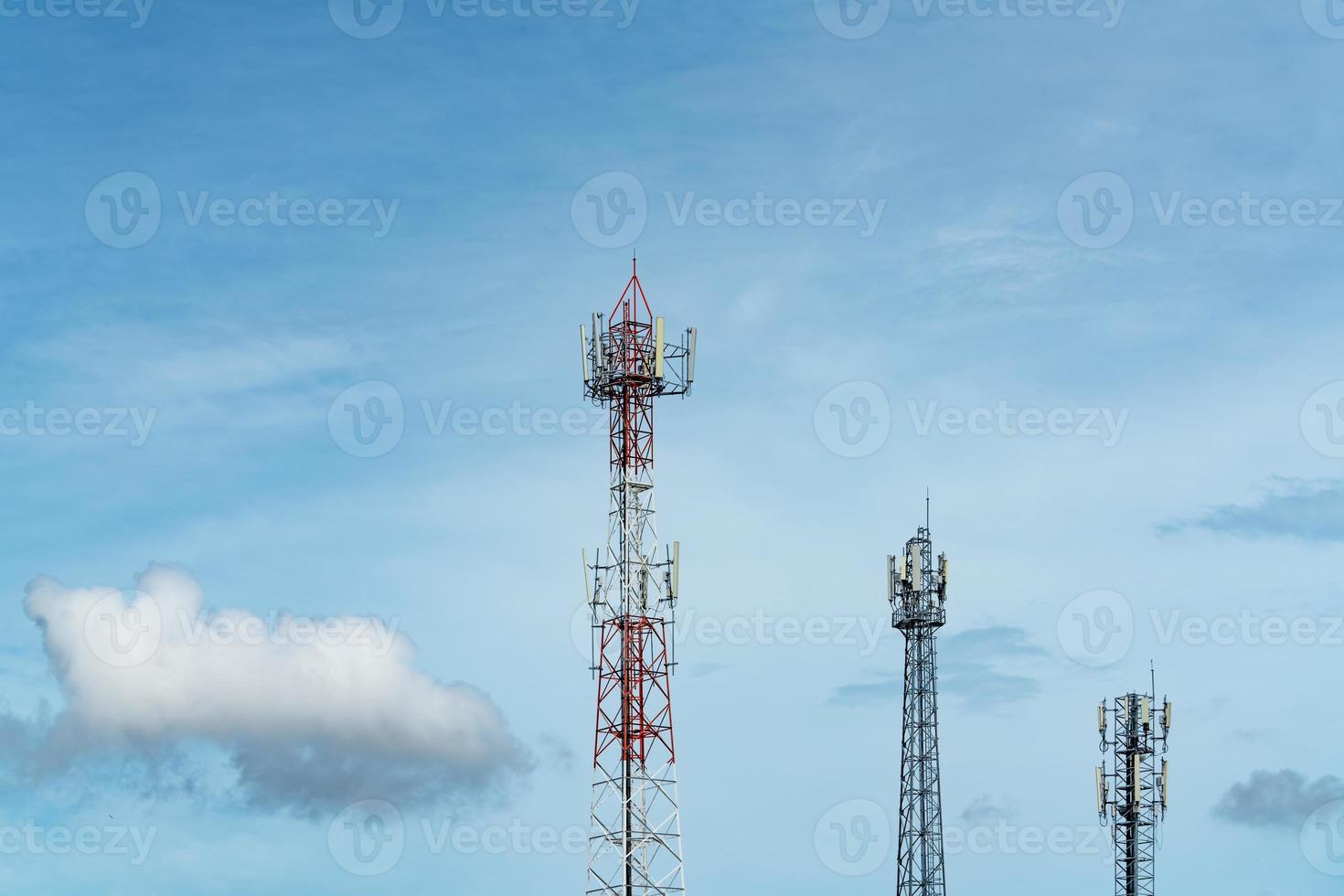 Telecommunication tower with blue sky and white clouds. Antenna on blue sky. Radio and satellite pole. Communication technology. Telecommunication industry. Mobile or telecom 4g network. Technology photo