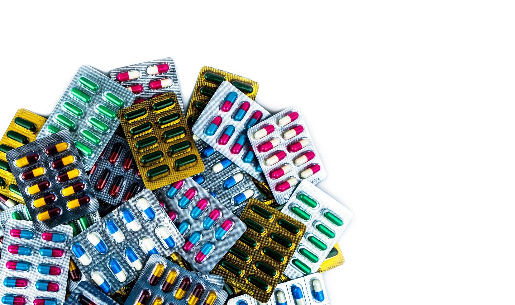 Top view of antibiotic capsule pills in blister pack isolated on white background. Pharmaceutical industry. Antibiotic drug resistance concept. Antimicrobial drugs. Colorful capsule pills. Healthcare. photo