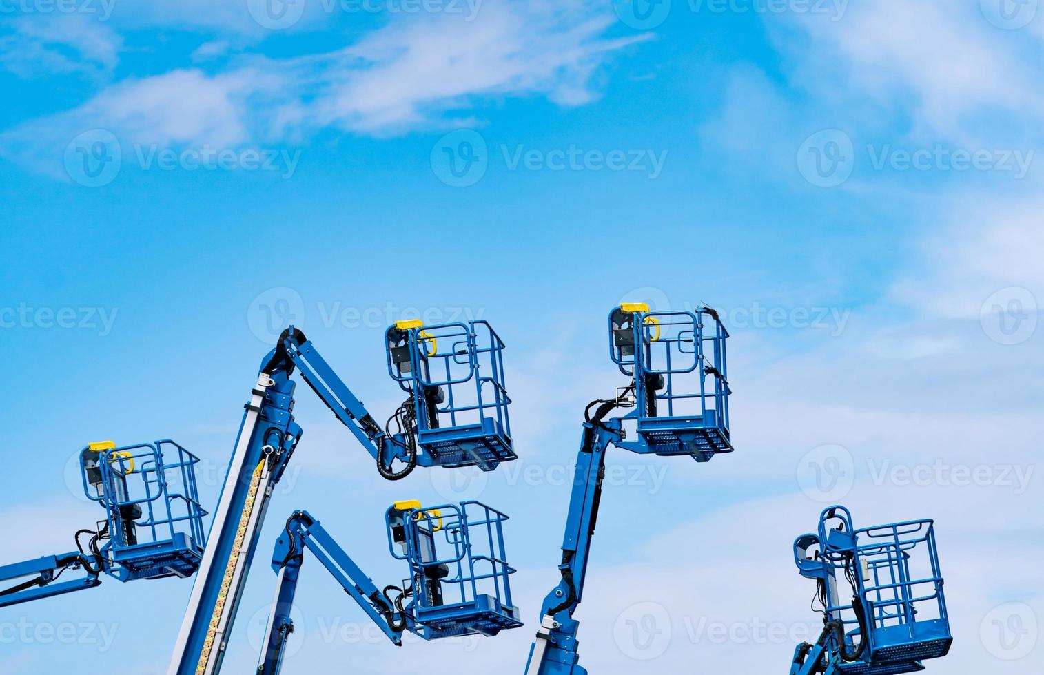 Articulated boom lift. Aerial platform lift. Telescopic boom lift against blue sky. Mobile construction crane for rent and sale. Maintenance and repair hydraulic boom lift service. Crane dealership. photo