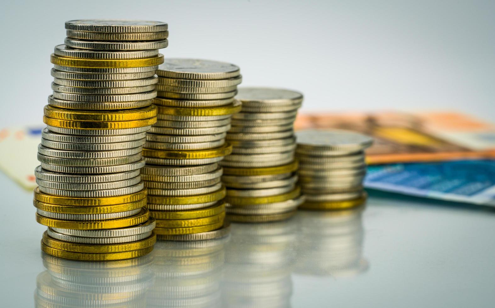 Macro shot detail of golden and silver color coin stacks on  with banknotes . Business and finance growth, saving money, investment and interest concept. photo