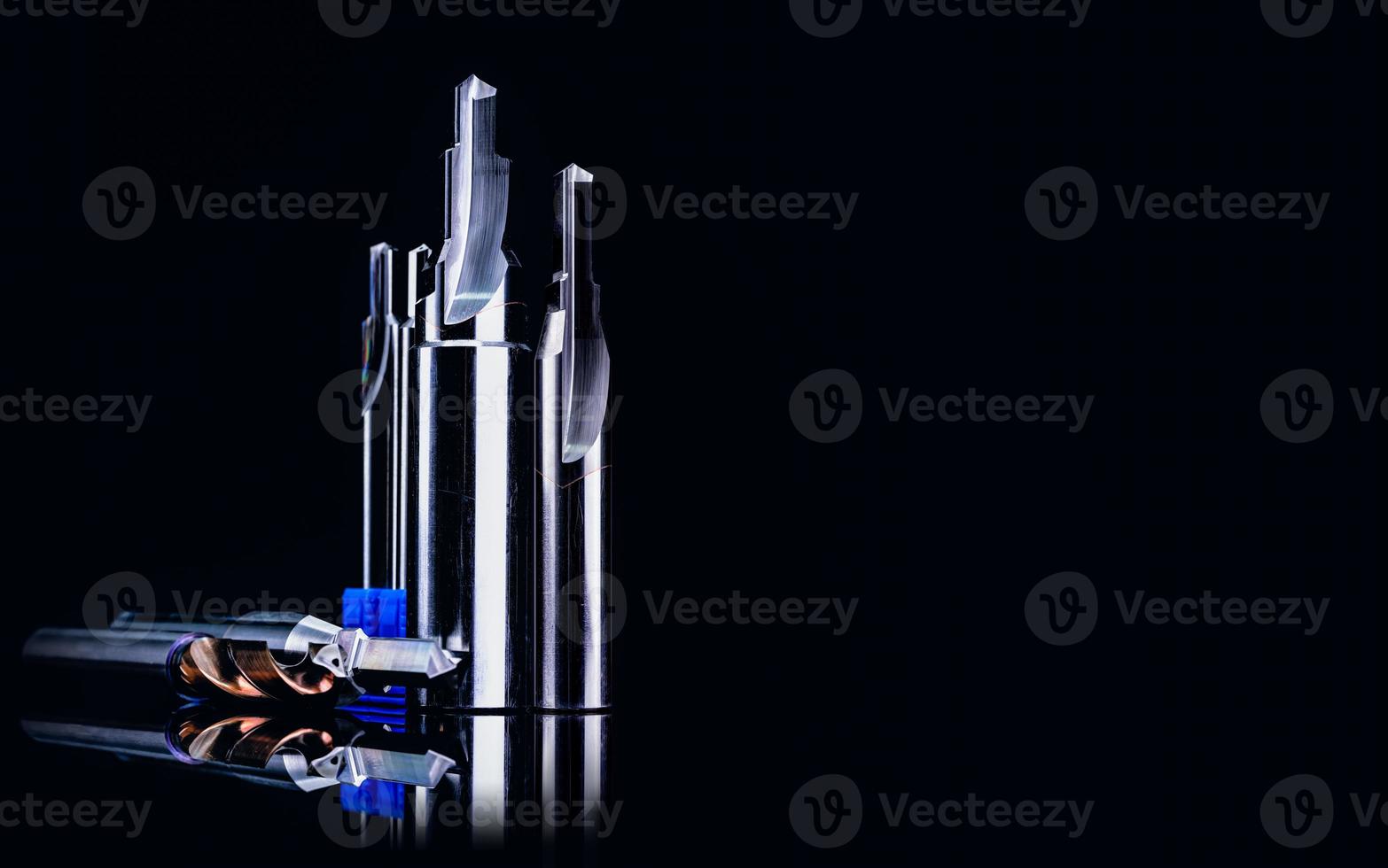 Special tools isolated on dark background. Made to order special tools. Coated step drill and reamer detail. HSS cemented carbide. Carbide cutting tool for industrial applications. Engineering tools. photo