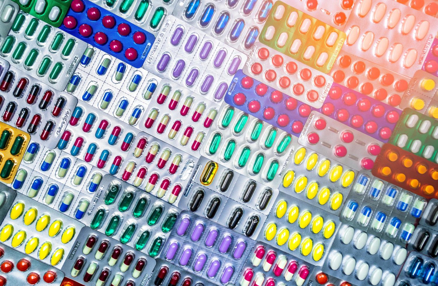 Colorful of tablets and capsules pill in blister packaging arranged with beautiful pattern with flare light. Pharmaceutical industry concept. Pharmacy drugstore. Antibiotic drug resistance. Defective. photo