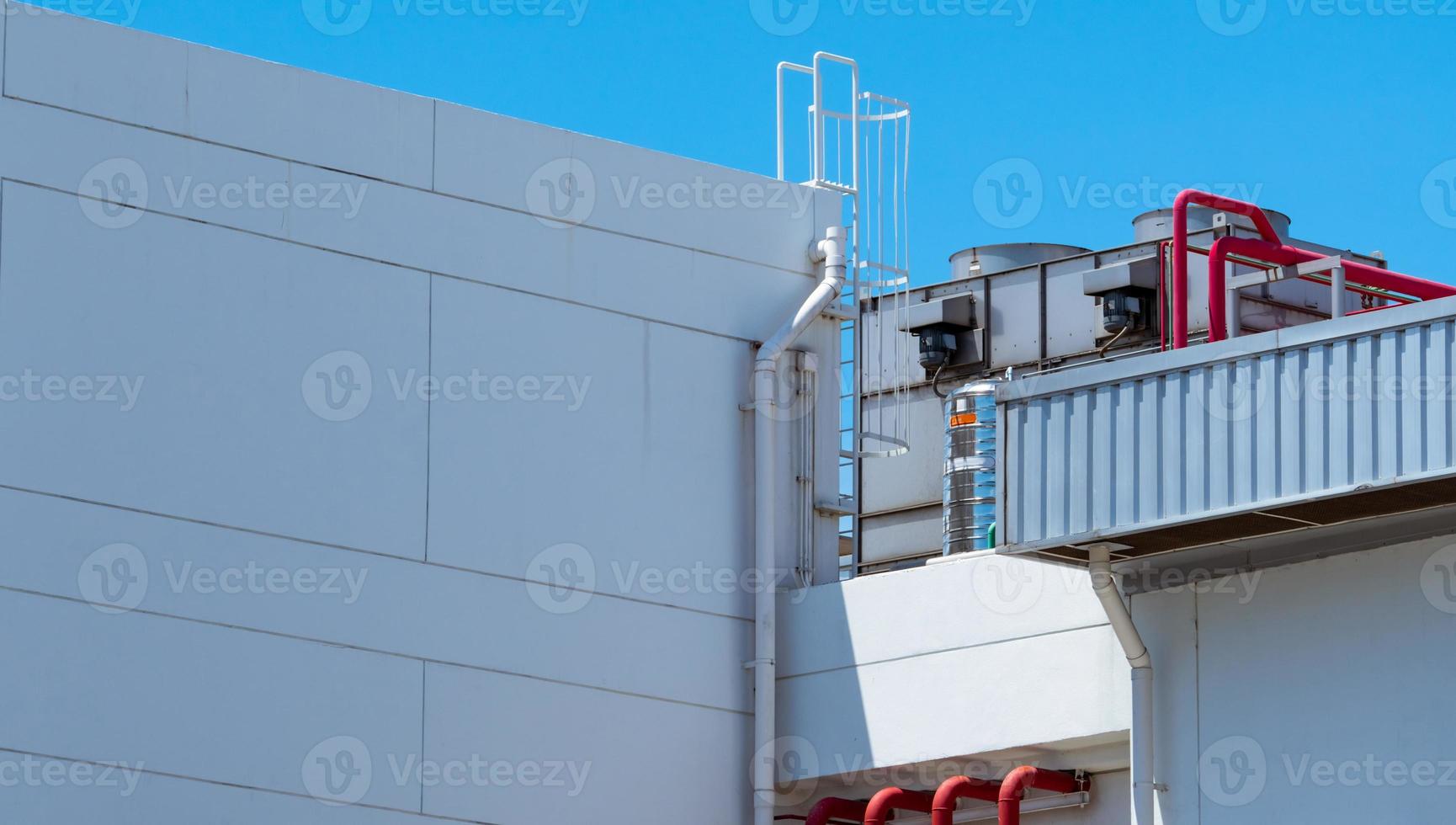 Cooling tower on roof top of building. Industrial air cooling system. Air chiller. Unit of air conditioner. Air cooled chiller with piping system on rooftop of building. Cooling tower outside building photo