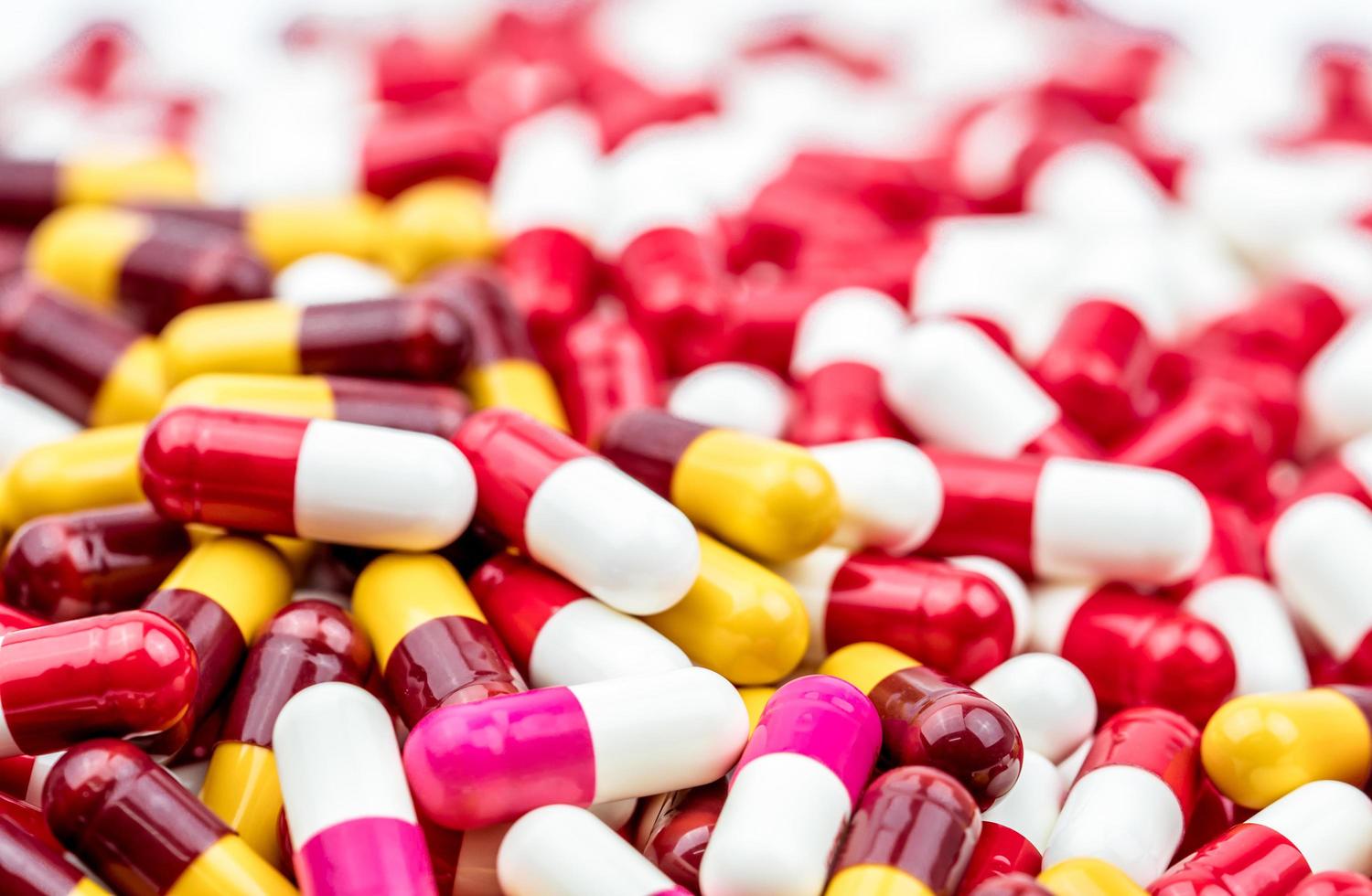 Pile of colorful antibiotic capsule pills. Antibiotic drug resistance concept. Prescription drugs. Pharmaceutical industry. photo