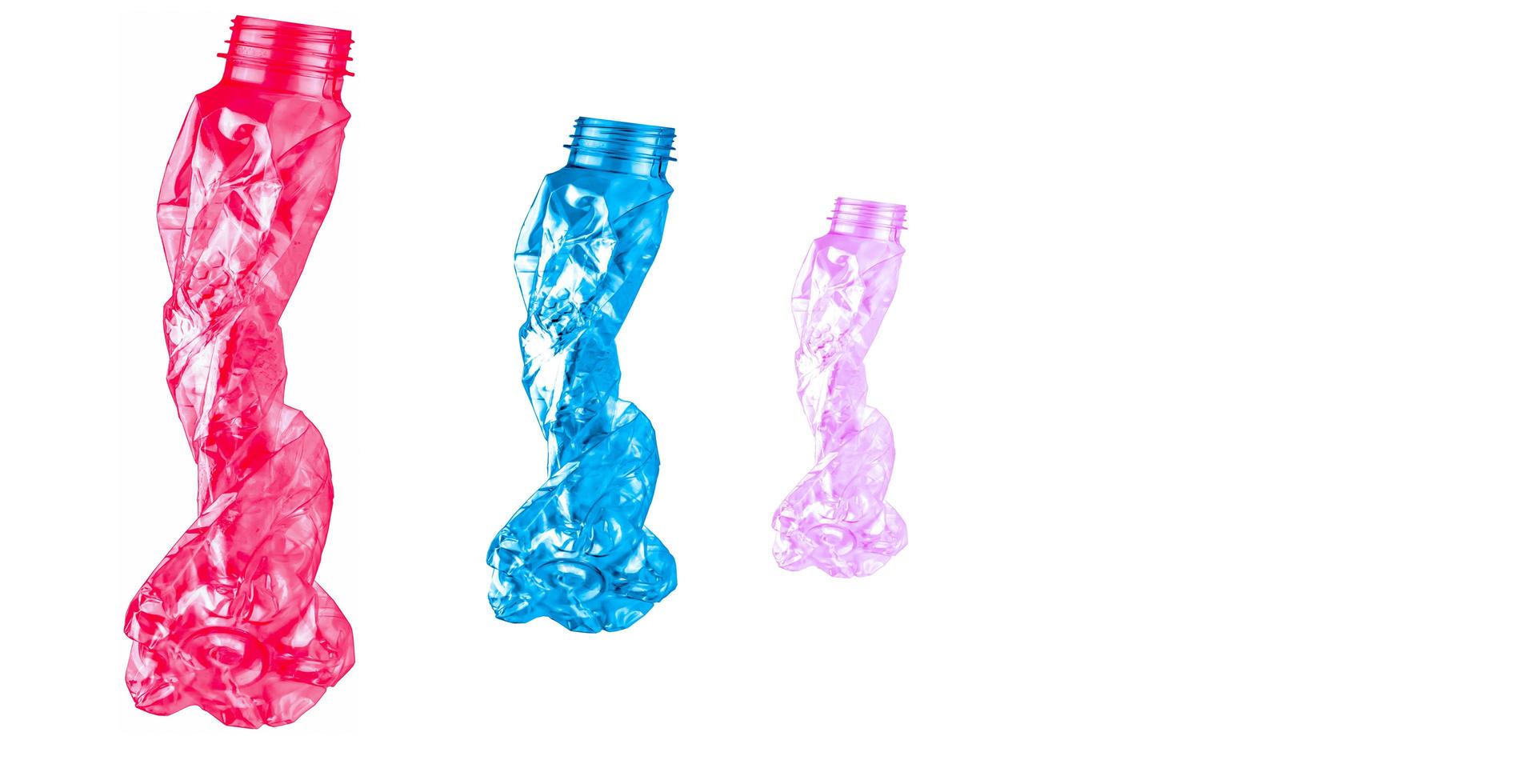 Waste of red, blue, and pink plastic bottles. Twisted empty bottle. Plastic bottle waste for recycle in recycling business. Plastic waste management. Reduce and reuse plastic. PET bottle for recycle. photo