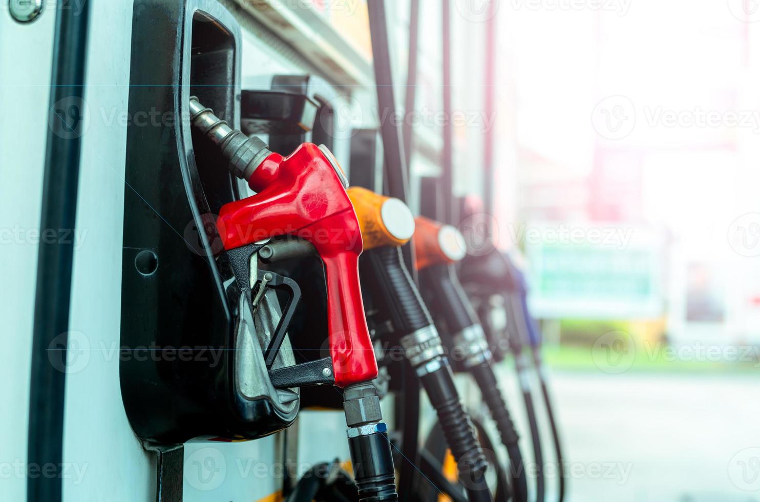 Petrol pump filling fuel nozzle in gas station. Fuel dispenser machine. Refuel fill up with petrol gasoline. Petrol industry and service. Red petrol fuel nozzle. Petroleum oil industry. Oil crisis. photo