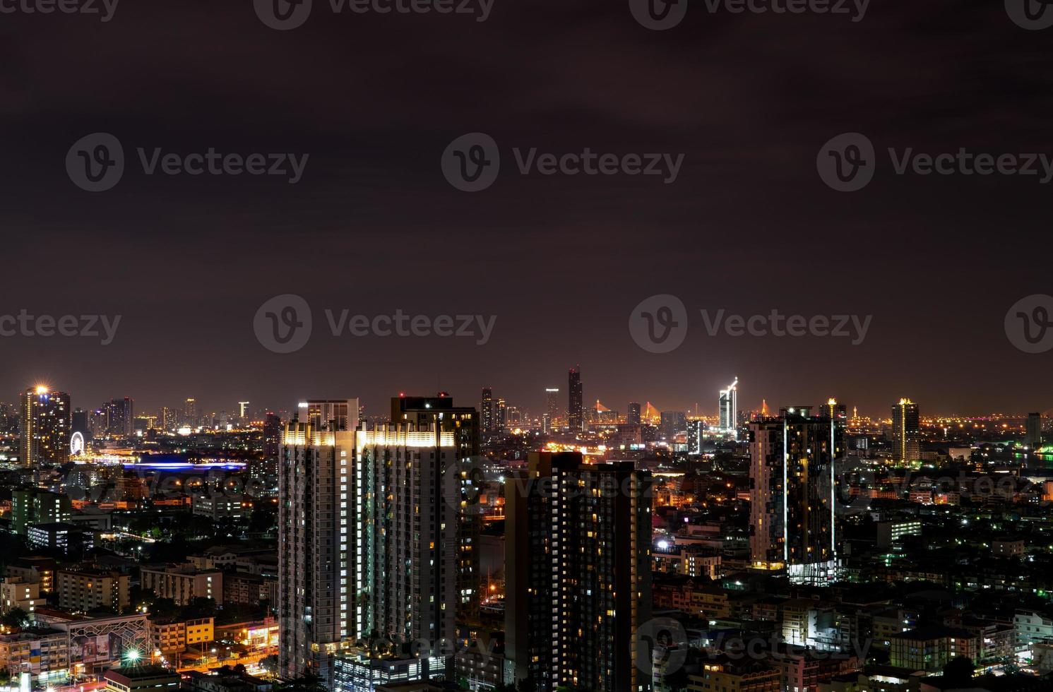 Cityscape of modern building in the night. Modern architecture office building. Skyscraper with beautiful evening sky. Business and financial center building. Apartment in the city with night light. photo