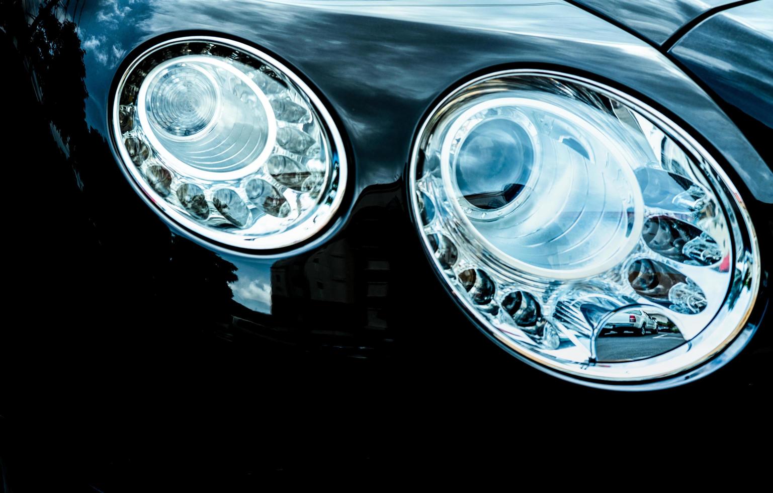 Closeup detail of LED headlight luxury car. Beautiful modern elegance headlamp car. Black automobile. Automotive industry technology. Auto parts business concept. photo