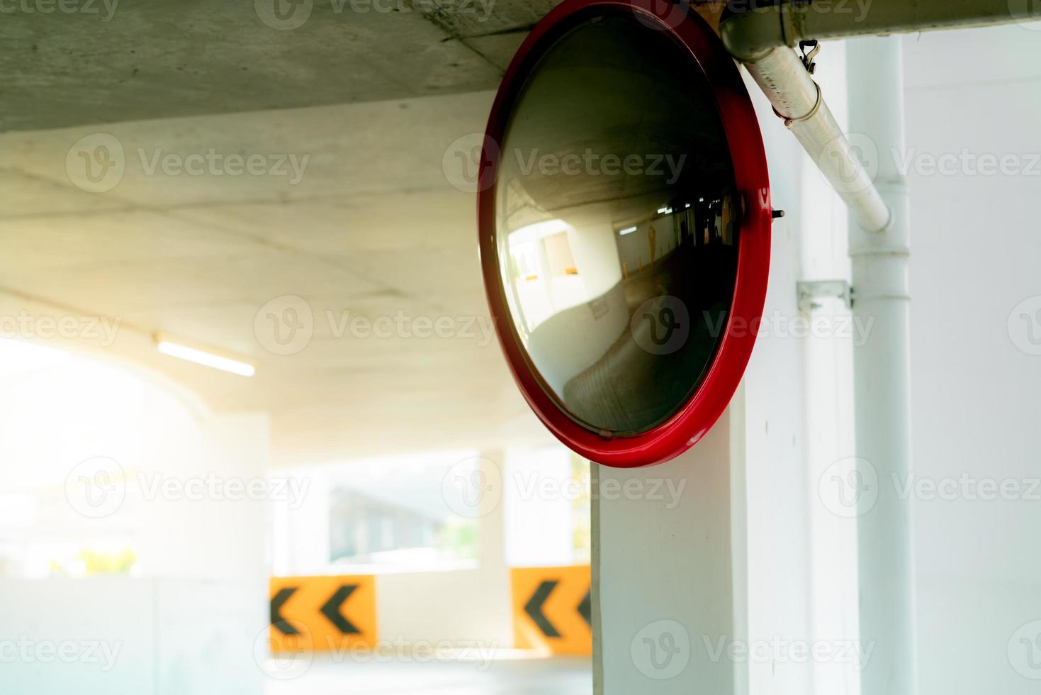 Convex safety mirror at curve of indoor car parking lot to reduce risk
