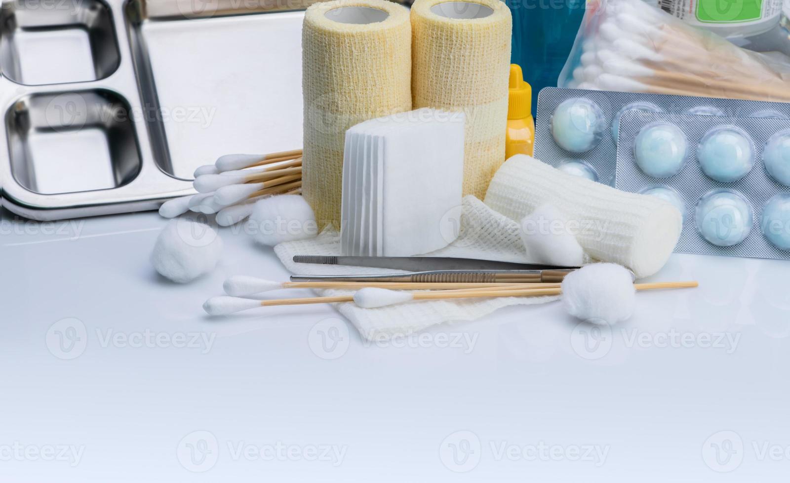 Wound care dressing set. Medical supply for diabetes, surgical and accidental wounds care. Medical equipment for nurse. Forceps, cotton stick, conform bandage, and elastic cohesive retention bandage. photo