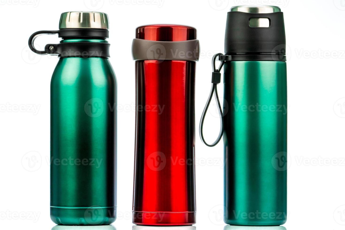 Thermos bottle isolated on white background. Coffee or tea reusable bottle container. Thermos travel tumbler. Insulated drink container. Red and green stainless steel thermos water flask. Zero waste. photo